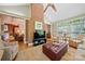 Open living area with brick fireplace and a wall of windows offering natural light and wooded views at 10609 Oak Pond Cir, Charlotte, NC 28277