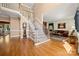 Elegant staircase with hardwood floors and carpeted steps leading to upstairs at 10609 Oak Pond Cir, Charlotte, NC 28277