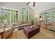Bright sunroom featuring many windows offering views of the surrounding nature, perfect for relaxation at 10609 Oak Pond Cir, Charlotte, NC 28277