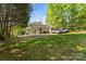 Expansive backyard featuring a detached garage, ample parking, and mature trees at 1068 14Th Nw Ave, Hickory, NC 28601