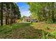 Secluded backyard with mature trees and a detached garage, offering privacy and space at 1068 14Th Nw Ave, Hickory, NC 28601