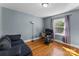 Comfortable bedroom featuring hardwood floors, a window with curtains, and a workspace at 1068 14Th Nw Ave, Hickory, NC 28601