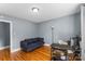 Simple bedroom setup with hardwood floors, a sofa, and a small desk at 1068 14Th Nw Ave, Hickory, NC 28601