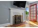 Close-up of the living room fireplace with a decorative screen and access to the porch at 1068 14Th Nw Ave, Hickory, NC 28601