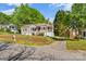 Charming home with red accents, mature trees, a cozy porch, and landscaped front yard at 1068 14Th Nw Ave, Hickory, NC 28601