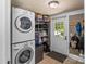 Functional laundry room with stacked washer/dryer, storage shelves, and easy access to the outdoors at 1068 14Th Nw Ave, Hickory, NC 28601