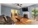 Cozy living room with hardwood floors, a fireplace, and access to the outdoors at 1068 14Th Nw Ave, Hickory, NC 28601