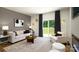 Cozy living room with plush seating, patterned curtains, stylish decor, and a sliding glass door to the backyard at 121 Falling Up Ln, Salisbury, NC 28147
