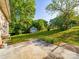 Spacious backyard featuring a storage shed, concrete patio, and mature trees at 1277 Rainbow Cir, Catawba, SC 29704