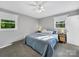 Bright bedroom with a ceiling fan, two windows, carpet flooring, and comfortable furnishings at 1277 Rainbow Cir, Catawba, SC 29704
