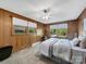 Cozy bedroom features wood paneled walls, with natural light from the two windows at 1277 Rainbow Cir, Catawba, SC 29704