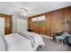 This bedroom offers cozy comfort, with wood walls and a ceiling fan for airflow at 1277 Rainbow Cir, Catawba, SC 29704