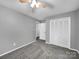 Bedroom with gray walls, carpet flooring, and a ceiling fan and closet with doors at 1277 Rainbow Cir, Catawba, SC 29704