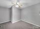 Bedroom with neutral gray walls, carpet flooring, and a ceiling fan and light fixture at 1277 Rainbow Cir, Catawba, SC 29704