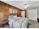 A stylish bedroom with carpet floors and wood walls, with a ceiling fan for air circulation at 1277 Rainbow Cir, Catawba, SC 29704