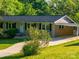 Traditional brick house with a spacious driveway, covered carport, and beautiful front yard landscaping at 1277 Rainbow Cir, Catawba, SC 29704