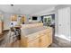 Open kitchen island with wood cabinets and drawers, connecting to a living room area with modern decor at 1277 Rainbow Cir, Catawba, SC 29704