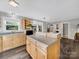 Bright kitchen with a large island, hardwood floors, and a view into the living area at 1277 Rainbow Cir, Catawba, SC 29704