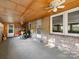 Sun room features multiple windows, two doors, ceiling fans, and brick and wood siding at 1277 Rainbow Cir, Catawba, SC 29704