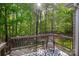 A cozy back deck is set amongst mature trees that create a serene view from your backyard at 1317 Waynewood Dr, Waxhaw, NC 28173