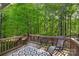 A cozy back deck is set amongst mature trees that create a serene view from your backyard at 1317 Waynewood Dr, Waxhaw, NC 28173