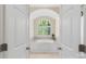 This primary bathroom has a large soaking tub nestled under a window at 1317 Waynewood Dr, Waxhaw, NC 28173