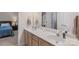 This bathroom includes a dual sink vanity, and a doorway to the bedroom at 1317 Waynewood Dr, Waxhaw, NC 28173