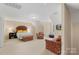 This bonus room boasts generous space, a sitting area, and a large bed at 1317 Waynewood Dr, Waxhaw, NC 28173