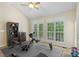 Well-lit exercise room with neutral walls, large windows, and exercise equipment at 1317 Waynewood Dr, Waxhaw, NC 28173