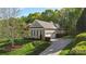 View of the home's side exterior with a two-car garage, manicured landscaping, and a well-maintained lawn at 1317 Waynewood Dr, Waxhaw, NC 28173