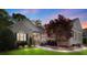 Charming brick home featuring manicured landscaping and a welcoming entrance, with a beautiful tree in the front yard at 1317 Waynewood Dr, Waxhaw, NC 28173
