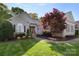 Charming brick home featuring manicured landscaping and a welcoming entrance, with a beautiful tree in the front yard at 1317 Waynewood Dr, Waxhaw, NC 28173