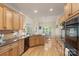 Bright and spacious kitchen with stainless appliances, wooden cabinets and breakfast area at 1317 Waynewood Dr, Waxhaw, NC 28173