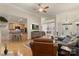Open living room with hardwood floors, fireplace, ceiling fan and access to kitchen at 1317 Waynewood Dr, Waxhaw, NC 28173