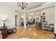 Open-concept living room with hardwood floors, a fireplace, and neutral tones, creating a comfortable and inviting space at 1317 Waynewood Dr, Waxhaw, NC 28173