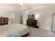 This main bedroom offers an elegant color scheme, tray ceiling, and an abundance of natural light at 1317 Waynewood Dr, Waxhaw, NC 28173