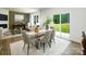 Dining room with glass table, six chairs, and a sliding glass door leading to the backyard at 133 Falling Up Ln, Salisbury, NC 28147