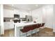 Modern kitchen featuring white cabinets, stainless steel appliances, a large island with seating, and elegant countertops at 133 Falling Up Ln, Salisbury, NC 28147