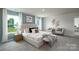 Spacious primary bedroom showcasing large windows, a plush bed, and stylish decor at 133 Falling Up Ln, Salisbury, NC 28147
