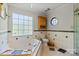 Bathroom with tub, shower, and dual windows offering natural light at 13843 Poppleton Ct, Charlotte, NC 28273