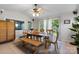Cozy dining room with tile flooring, ceiling fan, large window, and view of the backyard at 13843 Poppleton Ct, Charlotte, NC 28273