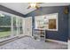 Bright dining room with view to back deck, access to outside, and built-in shelving at 13843 Poppleton Ct, Charlotte, NC 28273