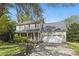 Traditional home with covered porch, attached two-car garage, and mature trees in a front yard at 13843 Poppleton Ct, Charlotte, NC 28273