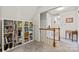 Hallway featuring a staircase, bookshelf, and wooden accents at 13843 Poppleton Ct, Charlotte, NC 28273