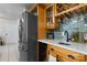 Well-appointed kitchen features stainless steel refrigerator, wine rack, bar sink, and charming backsplash at 13843 Poppleton Ct, Charlotte, NC 28273