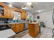 Spacious kitchen features wooden cabinets, tile countertops, and a central island at 13843 Poppleton Ct, Charlotte, NC 28273
