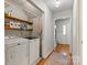 Convenient laundry room with washer, dryer, shelving, and access to the hallway and foyer at 13843 Poppleton Ct, Charlotte, NC 28273