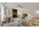 Comfortable living room features a brick fireplace, ceiling fan, and lots of natural light at 13843 Poppleton Ct, Charlotte, NC 28273