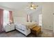 Inviting main bedroom features soft, natural light, ceiling fan, and comfortable furniture at 13843 Poppleton Ct, Charlotte, NC 28273