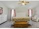 Inviting main bedroom features soft, natural light, ceiling fan, and comfortable furniture at 13843 Poppleton Ct, Charlotte, NC 28273